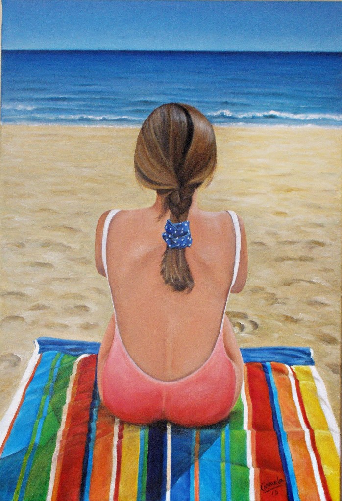 Niña mirando el mar desde la playa